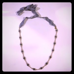 JCrew grey and white patterned gold necklace.